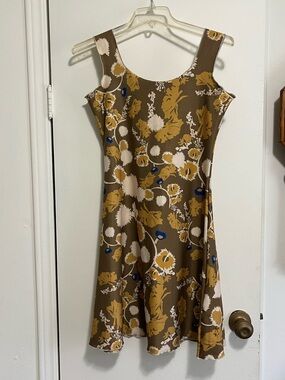 Sleeveless Reversible Floral A-Line Dress in Olive, golds, blue, and cream.